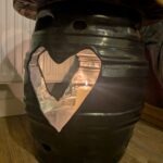Black beer barrel table with three plasma-cut heart openings