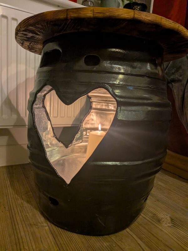 Black beer barrel table with three plasma-cut heart openings