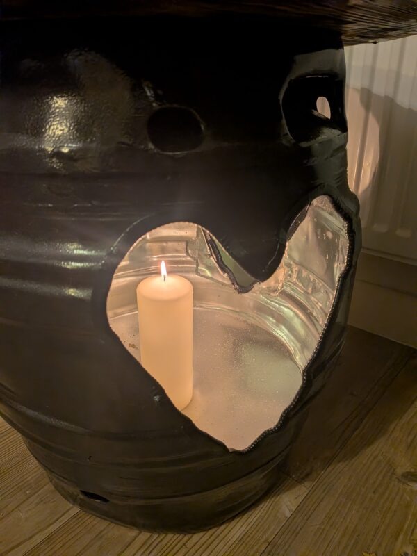 Black beer barrel table with three plasma-cut heart openings