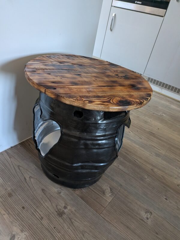 Burnt reclaimed pallet wood top on handmade beer barrel table