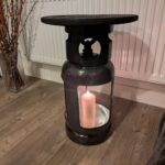 Upcycled gas cylinder coffee table with square cut-outs and scorched timber top