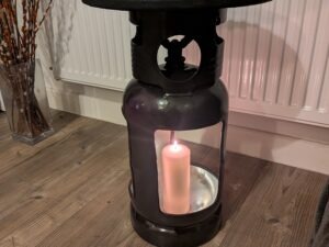 Upcycled gas cylinder coffee table with square cut-outs and scorched timber top