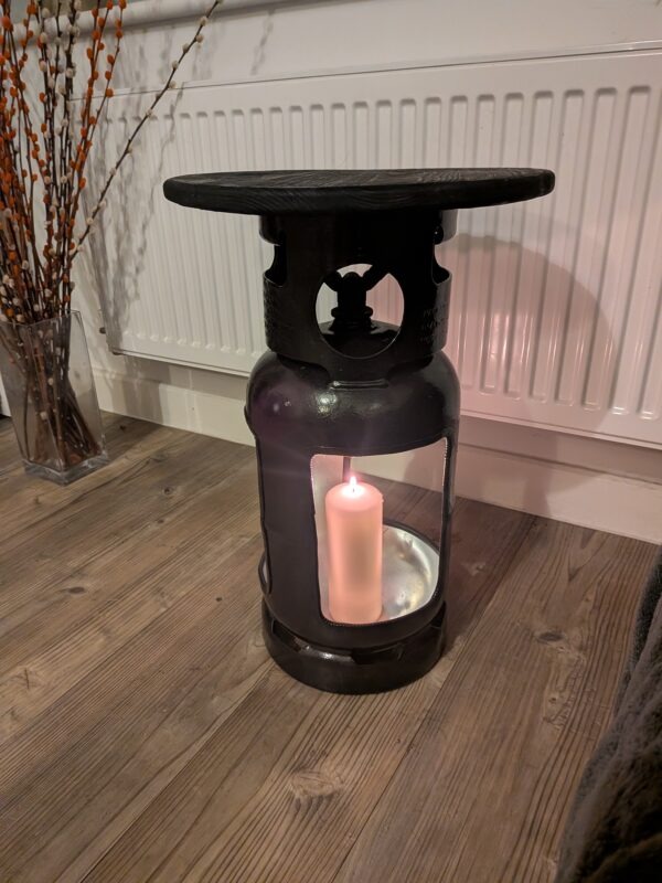 Upcycled gas cylinder coffee table with square cut-outs and scorched timber top
