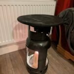 Upcycled gas cylinder coffee table with square cut-outs and scorched timber top