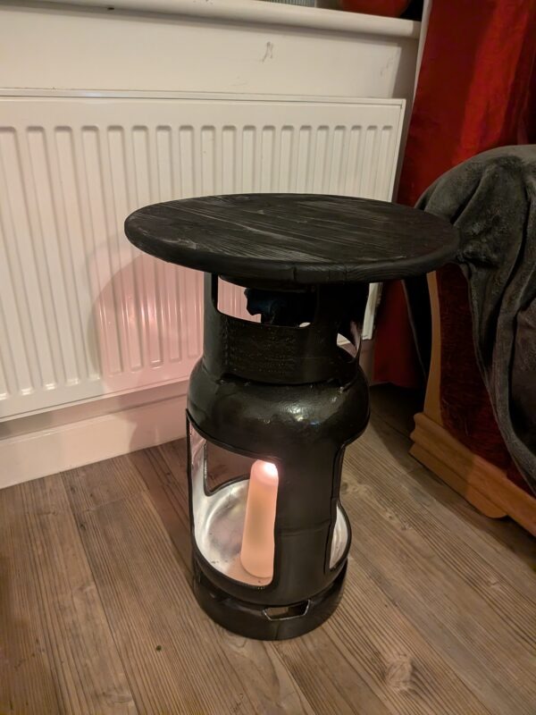 Upcycled gas cylinder coffee table with square cut-outs and scorched timber top