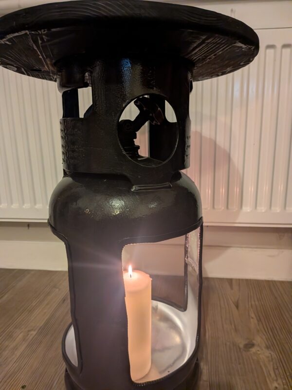 Upcycled gas cylinder coffee table with square cut-outs and scorched timber top