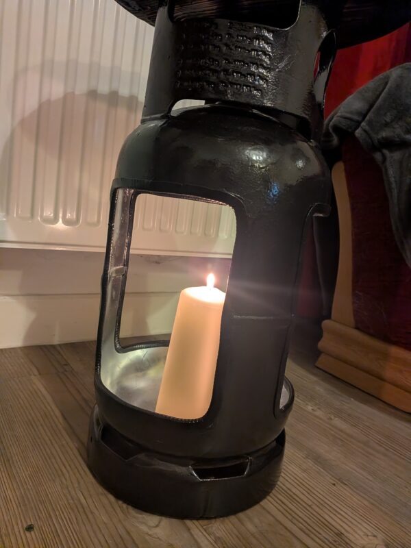 Upcycled gas cylinder coffee table with square cut-outs and scorched timber top