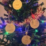 personalised christmas tree decorations hanging on a tree