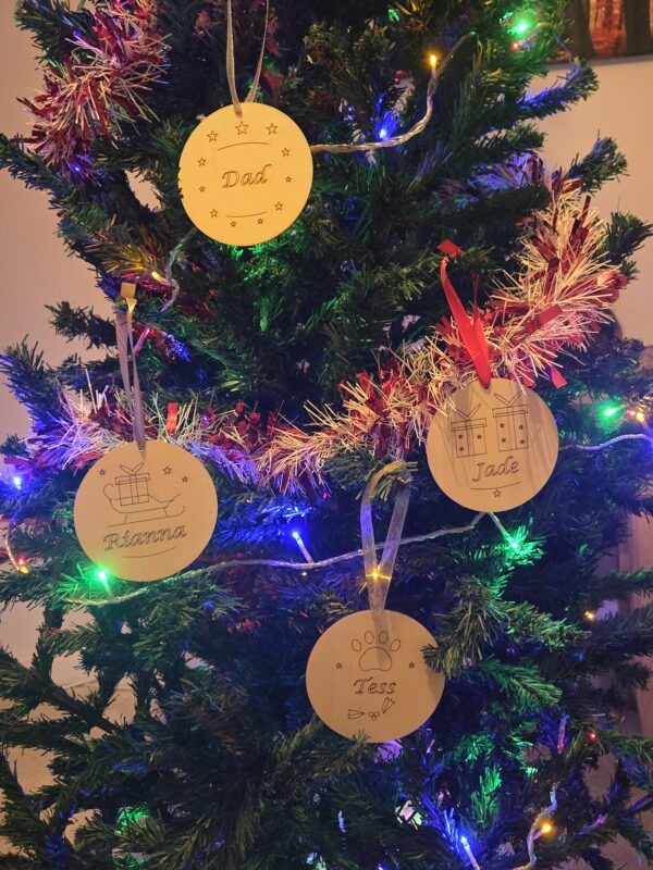 personalised christmas tree decorations hanging on a tree